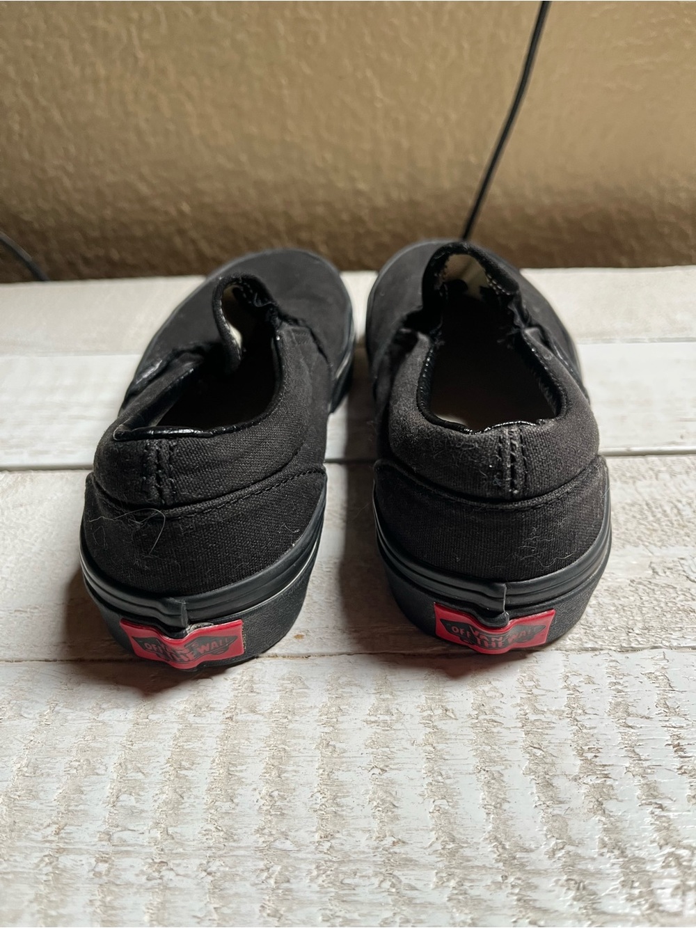 Vans Kids Black Slip-On Sneakers with Red Heel Logos